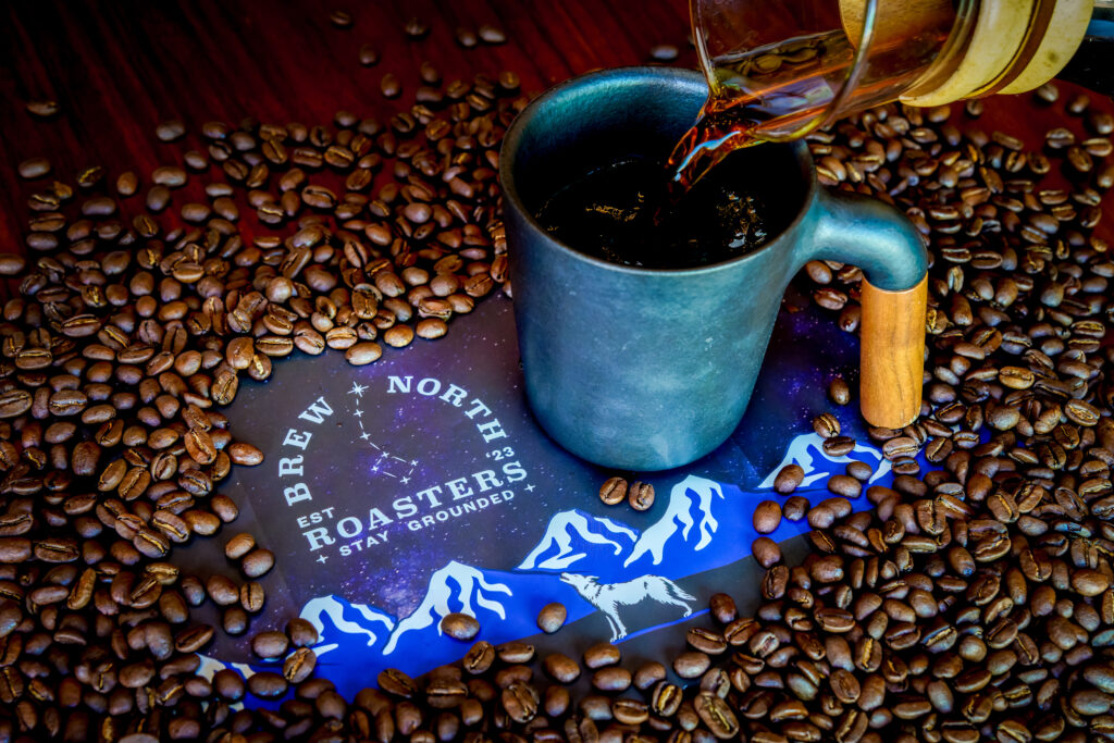 A Chemex pouring Brew North Roasters coffee into a cup.