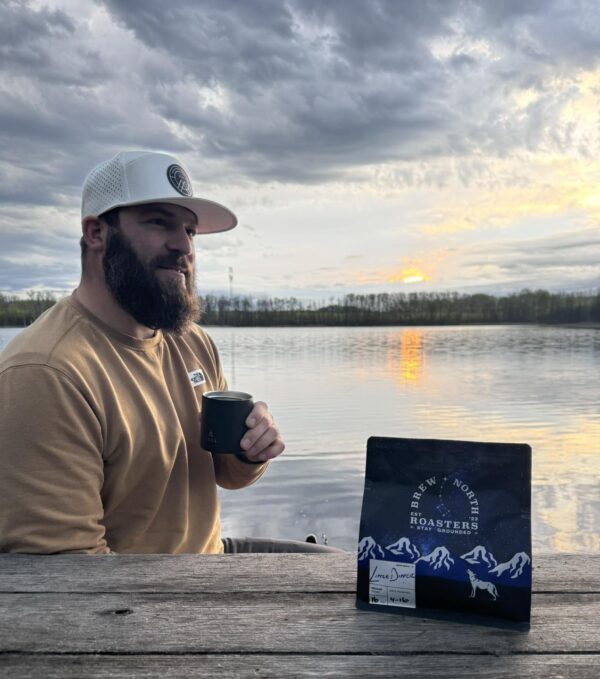 Matt Olsen Drinking Little Dipper coffee by a lake